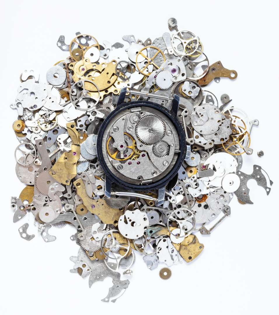 top view of mechanic watch on heap of spare parts