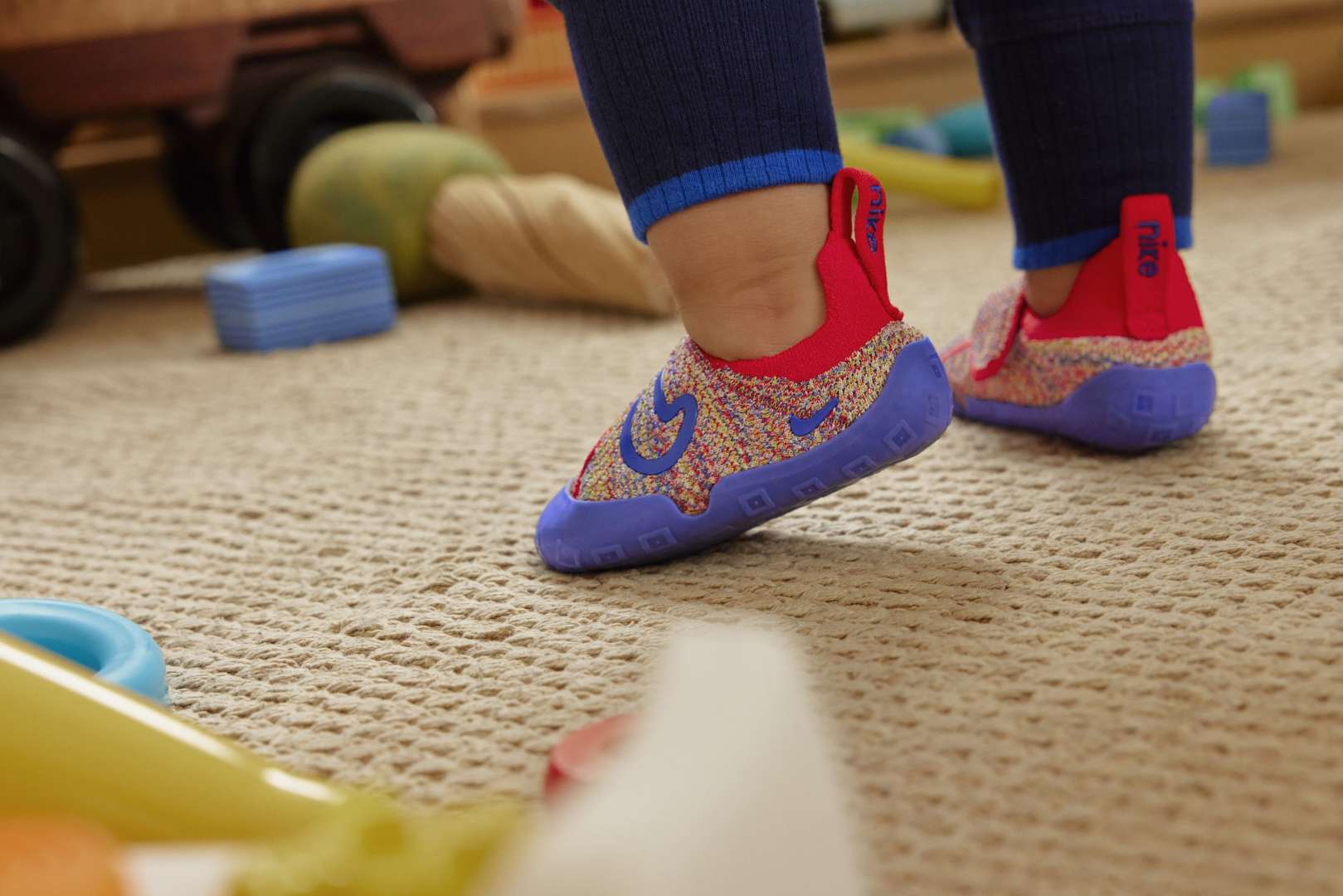 Toddler's feet in Nike Swoosh 1s walking in playroom