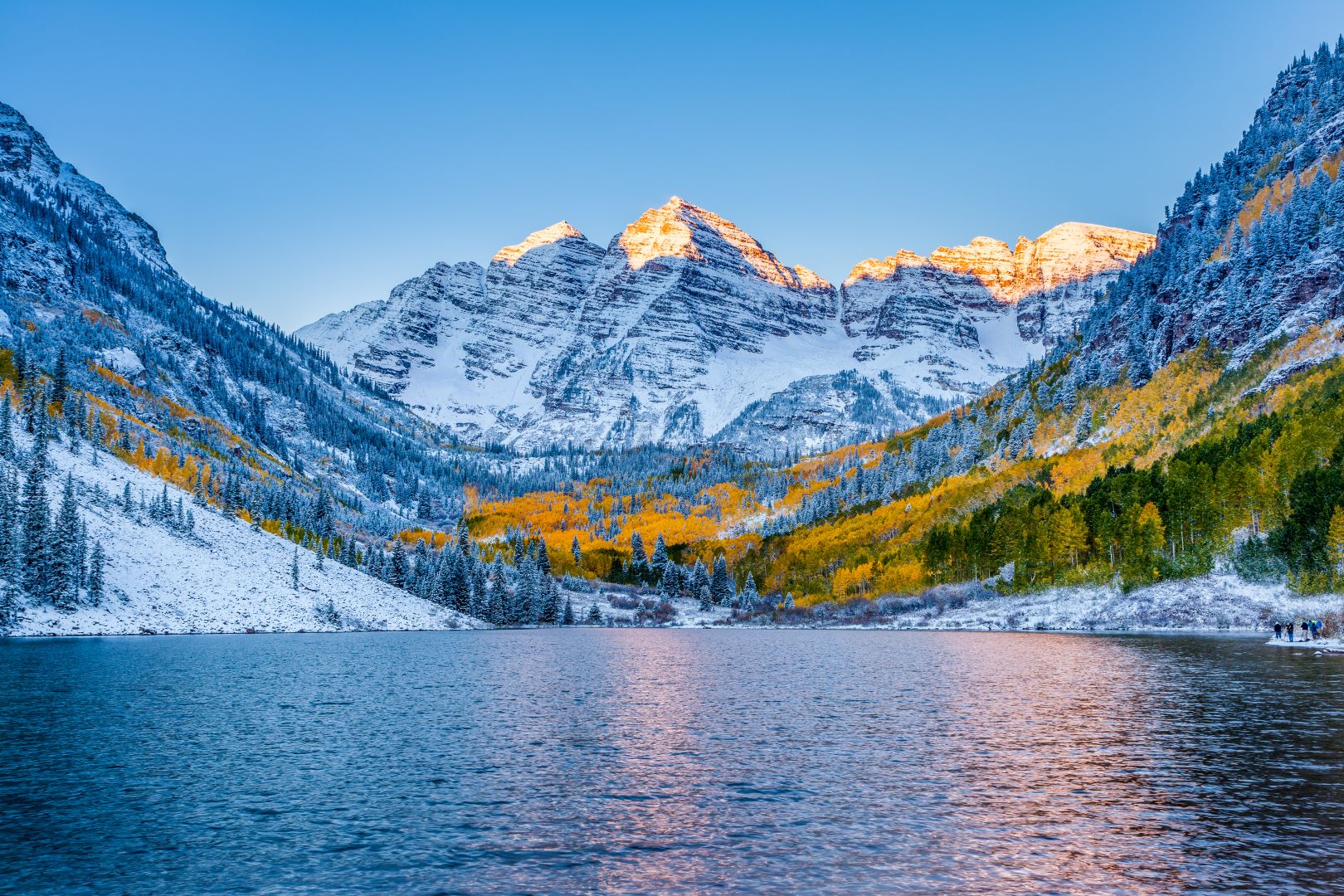 Snowy mountains and a lake at sunrise in Aspen, CO