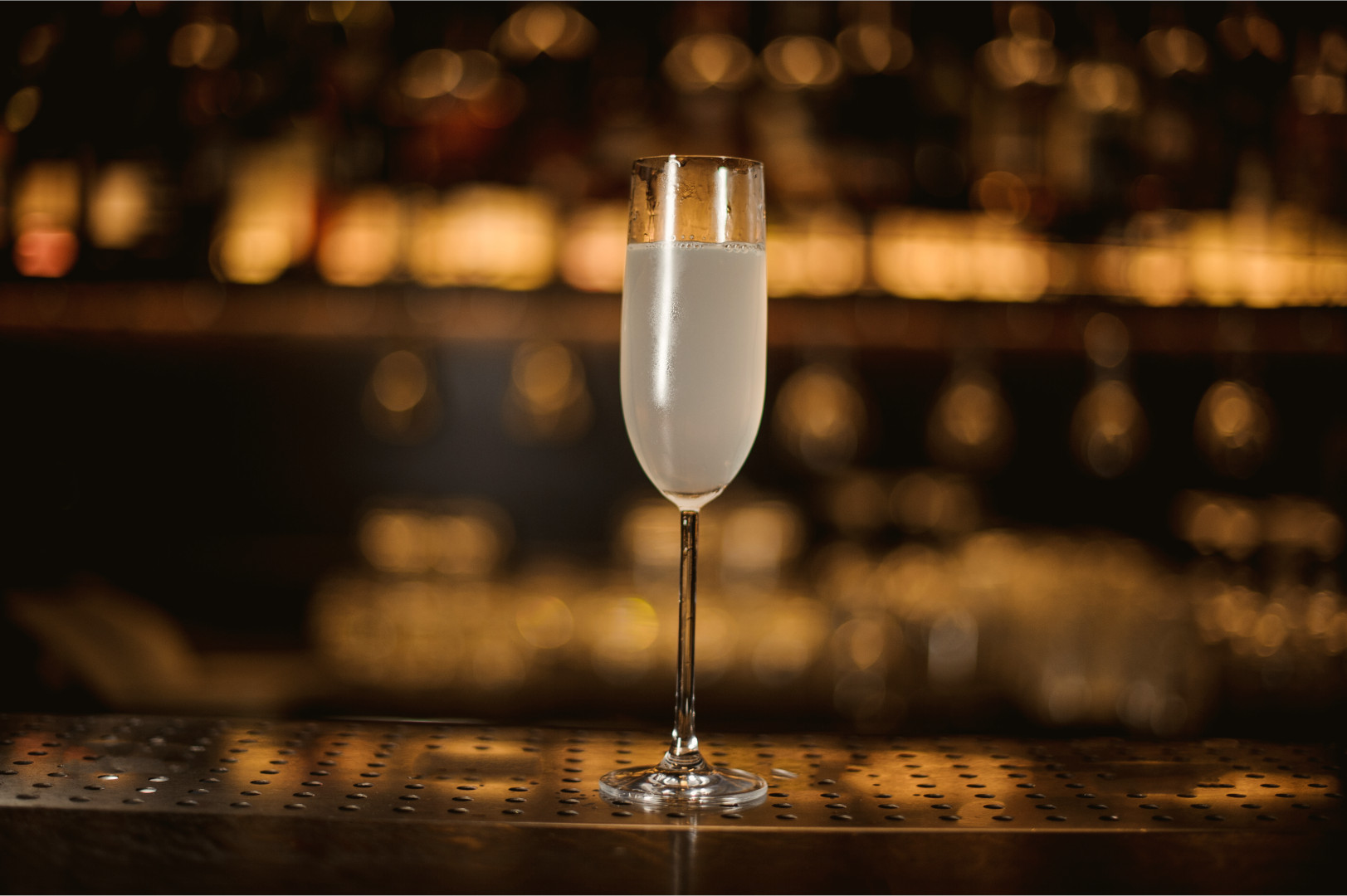 A French 75 sitting on a metal grated bar