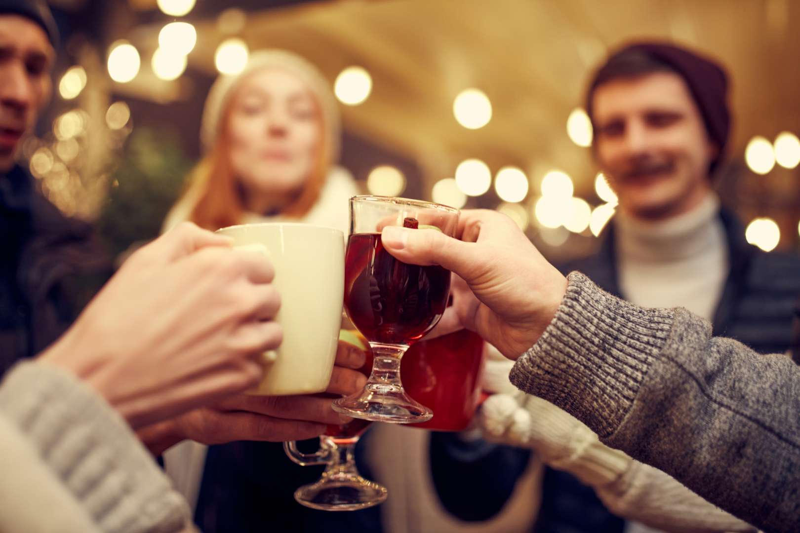 Group toasting with winter cocktails