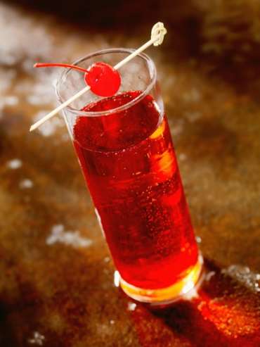 Shirley Temple in a tall glass with a cherry garnish
