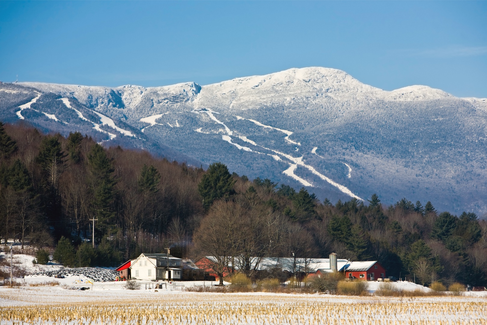 Snow-capped mountains above a farm in Stowe, VT