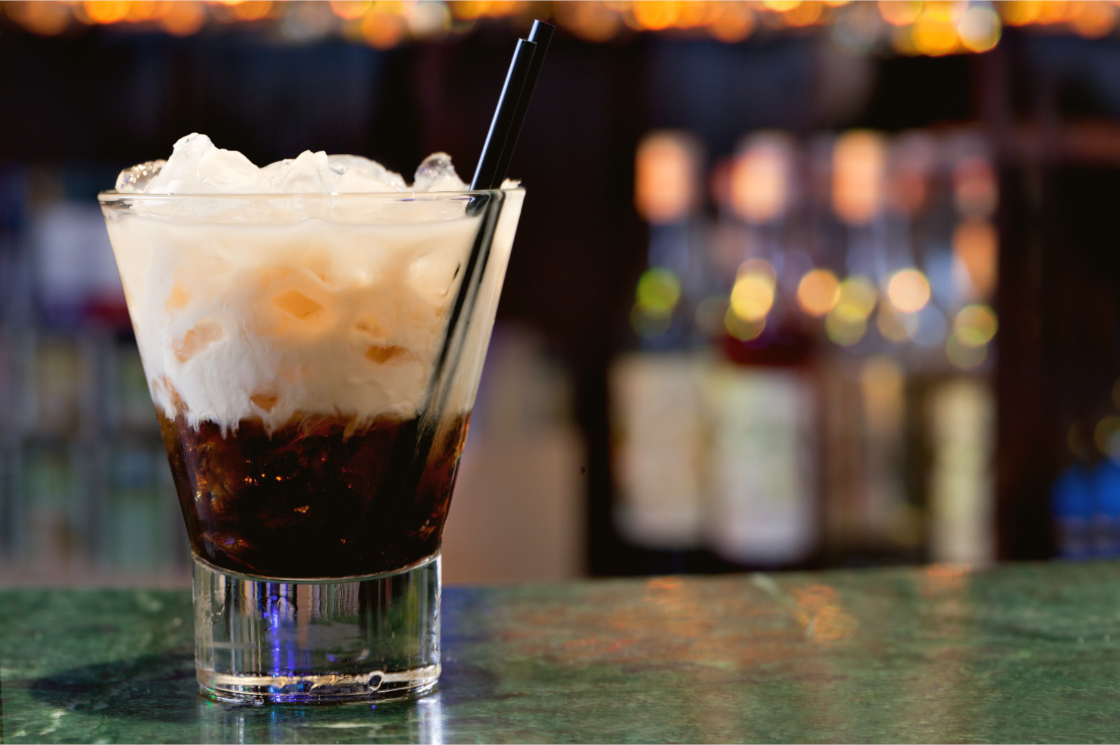 A white Russian sitting on a marble bar