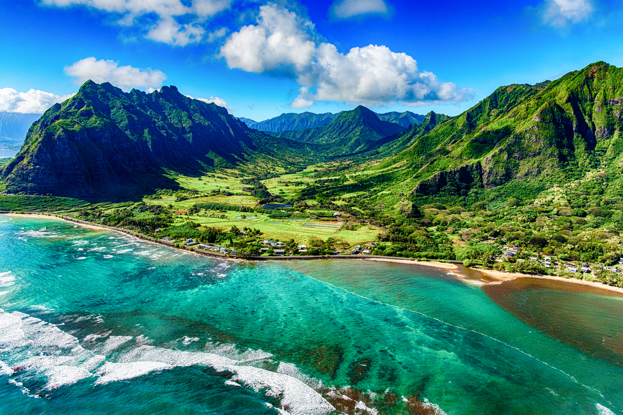 The beautiful and unique landscape of coastal Oahu, Hawaii, and the Kualoa Ranch, where Jurassic Park was filmed as shot from an altitude of about 1000 feet over the Pacific Ocean.